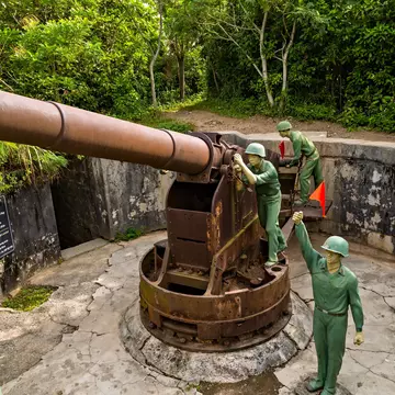 Cannon Fort Artillery gun surrounded by mannequin soldiers, Cat Ba Island, Vietnam.