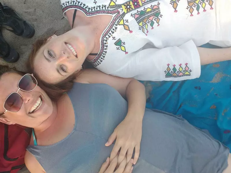 Amy Lynch and her sister lying on the beach on Toronto Island in 2016