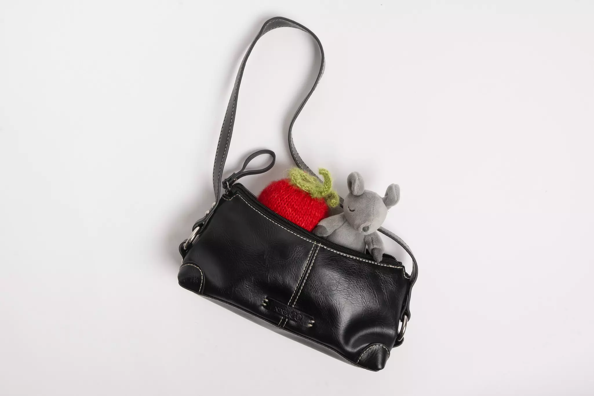A tiny purse with dolls in it.