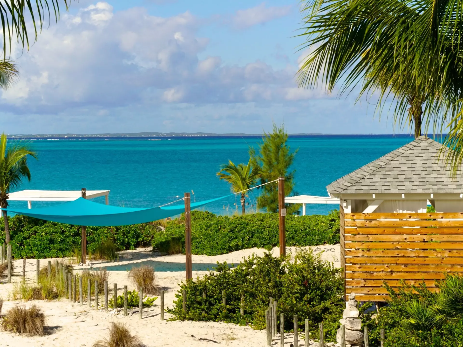 Providenciales, Turks and Caicos Islands. Grace Bay in Turks and Caicos is renown for its iconic turquoise waters, white sand beaches, seaside cabanas, sunny skies and warm weather.