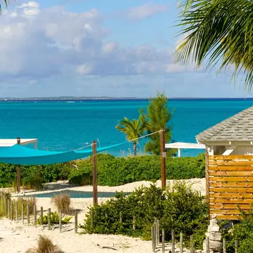 Providenciales, Turks and Caicos Islands. Grace Bay in Turks and Caicos is renown for its iconic turquoise waters, white sand beaches, seaside cabanas, sunny skies and warm weather.