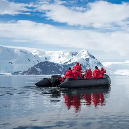 Inflatable boat full of tourists, watching for whales and seals, Antarctic Peninsula, Antarctica  License Type: media  Download Time: 2022-03-30T22:45:02.000Z  User: joe_lp  Is Editorial: No  purchase_order:   