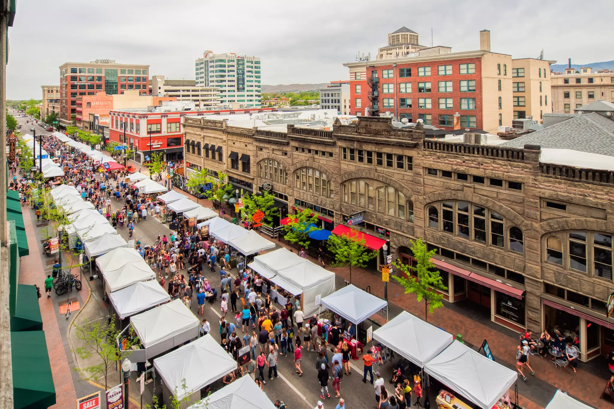 High-angle view of visitors crowding stalls during the Boise Farmers Market weekend in the late spring.