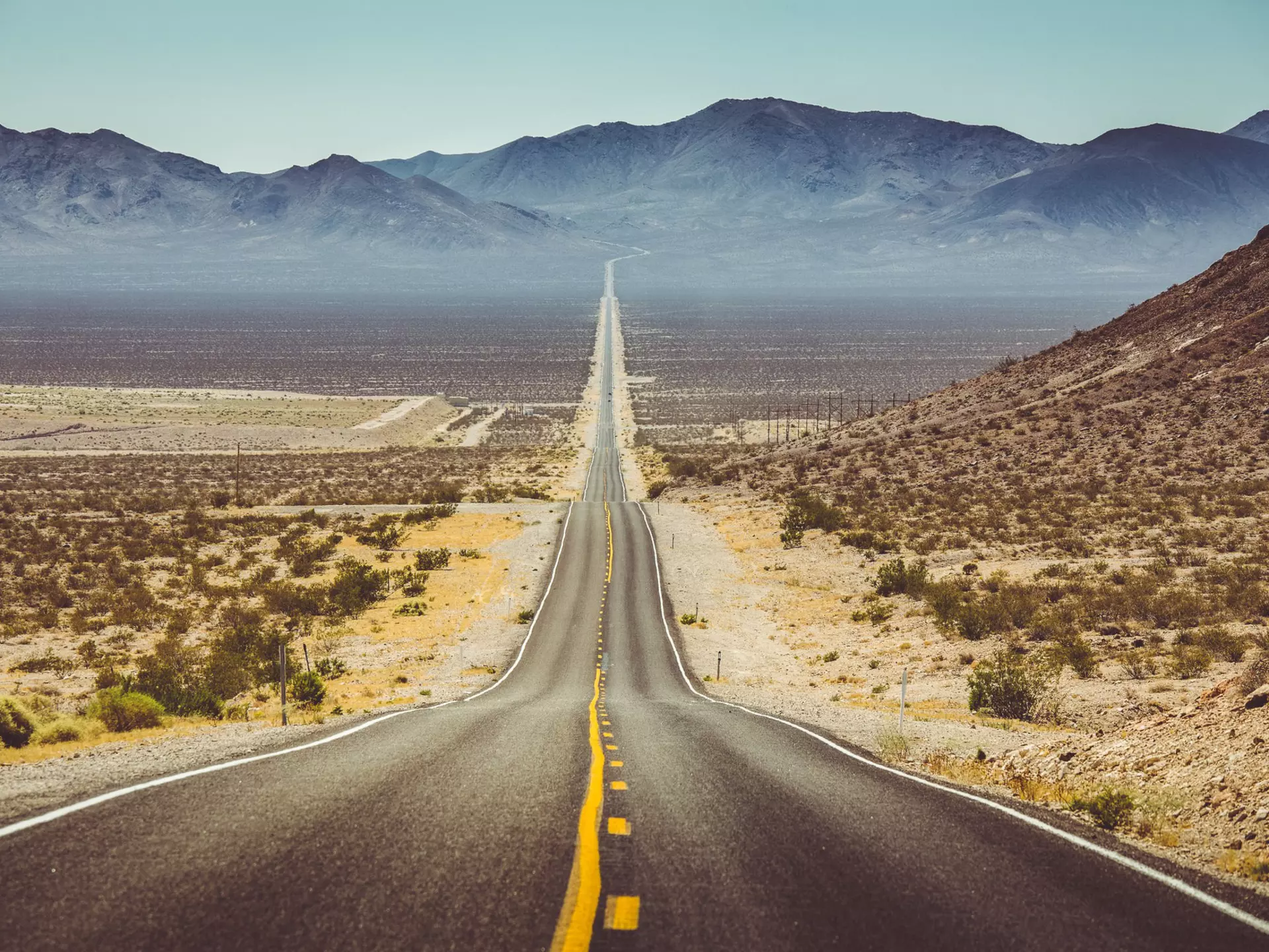 Long straight road through barren desert in the American Southwest with extreme heat haze on a sunny day.
593588213
america, american, american southwest, arizona, asphalt, california, death valley, death valley national park, desert, drive, dry, empty, highway, horizon, instagram, journey, landmark, landscape, lane, mojave, mountains, national park, nature, nevada, north america, outdoors, retro, road, road trip, rocks, route 66, sand, sierra nevada, street, tarmac, tourism, traffic, transport, transportation, travel, travel destination, u.s. route 66, united states, united states of america, usa, utah, vintage, vsco, west, wilderness