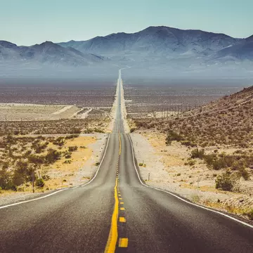 Long straight road through barren desert in the American Southwest with extreme heat haze on a sunny day.
593588213
america, american, american southwest, arizona, asphalt, california, death valley, death valley national park, desert, drive, dry, empty, highway, horizon, instagram, journey, landmark, landscape, lane, mojave, mountains, national park, nature, nevada, north america, outdoors, retro, road, road trip, rocks, route 66, sand, sierra nevada, street, tarmac, tourism, traffic, transport, transportation, travel, travel destination, u.s. route 66, united states, united states of america, usa, utah, vintage, vsco, west, wilderness