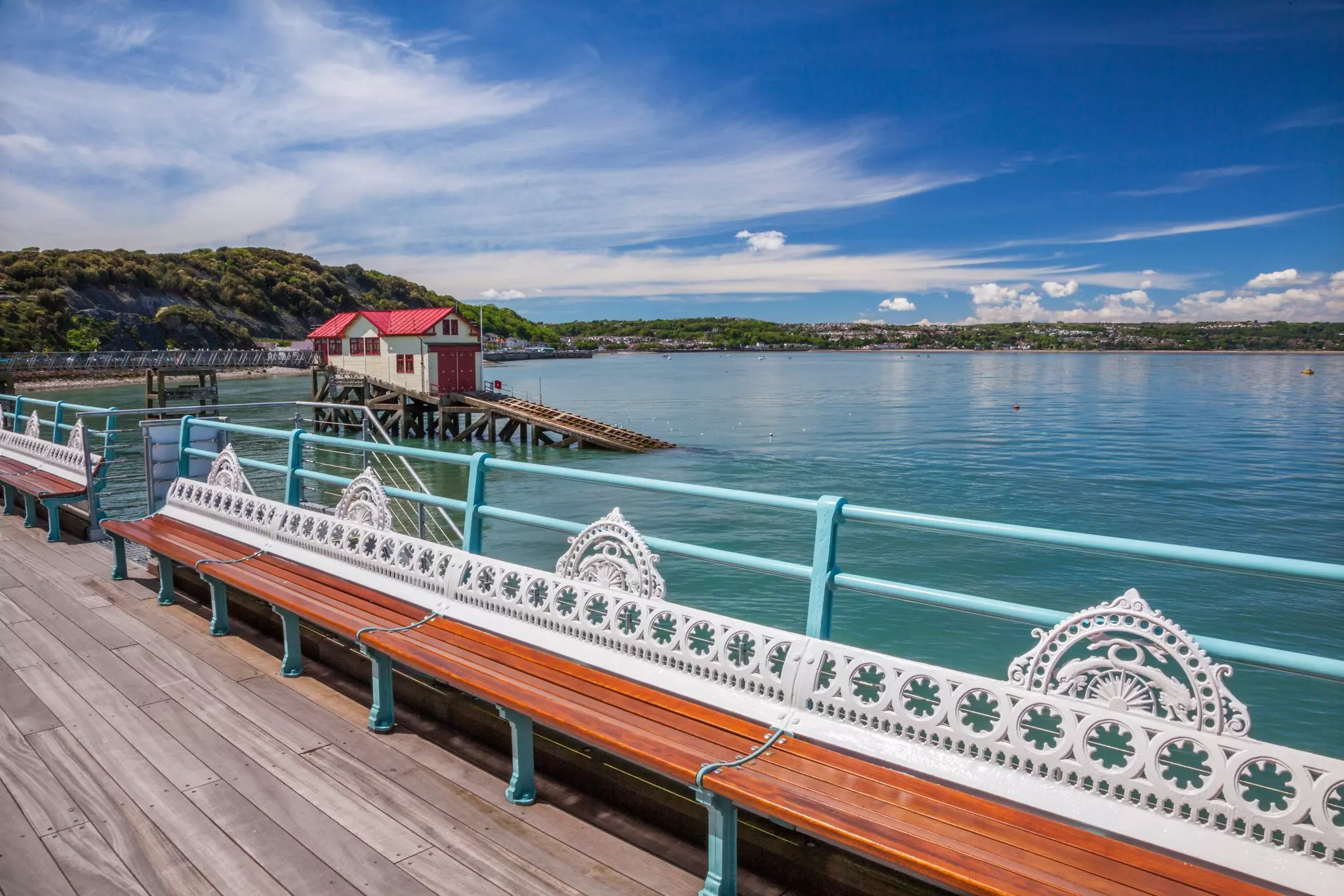 A view of Mumbles Pier on the Gower Peninsula in Wales, with Victorian cast-iron benches.
