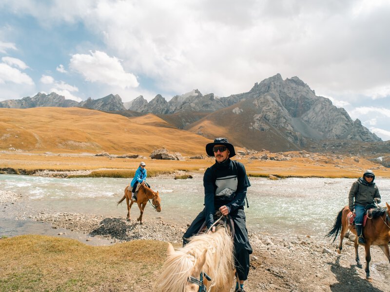 Tourists on horseback in Kurumduk valley Naryn province, Kyrgyzstan - 3 september 2025. High quality photo