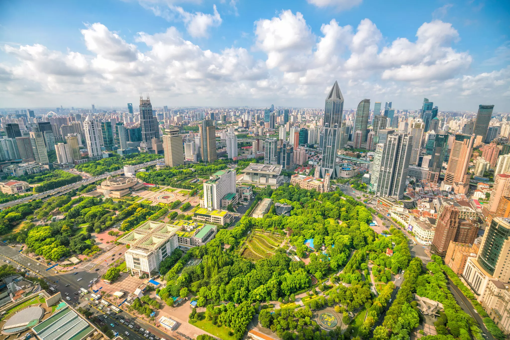 Aerial view of Shanghai city skyline with park in the foreground.