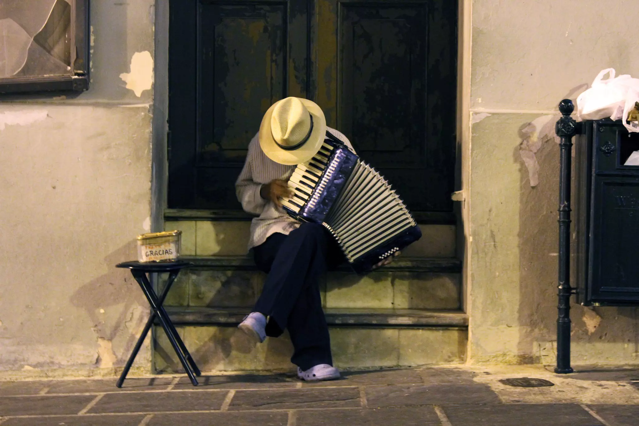 Man in a straw hat playing an accordion in Old San Juan