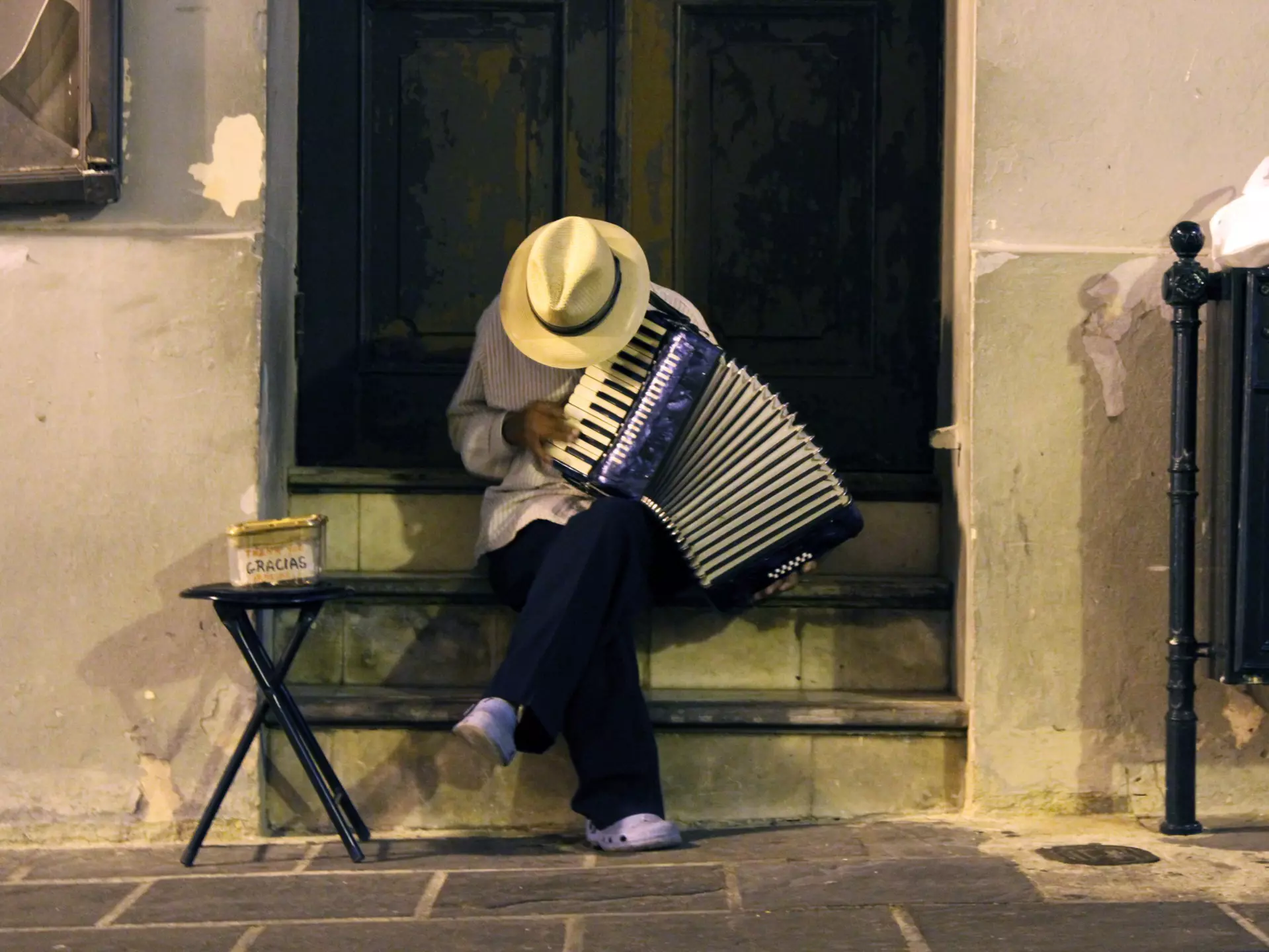 Man in a straw hat playing an accordion in Old San Juan
