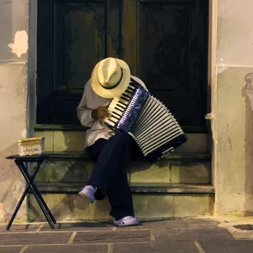 Man in a straw hat playing an accordion in Old San Juan