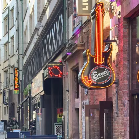  Neon signs outside bars on a pedestrianized street
