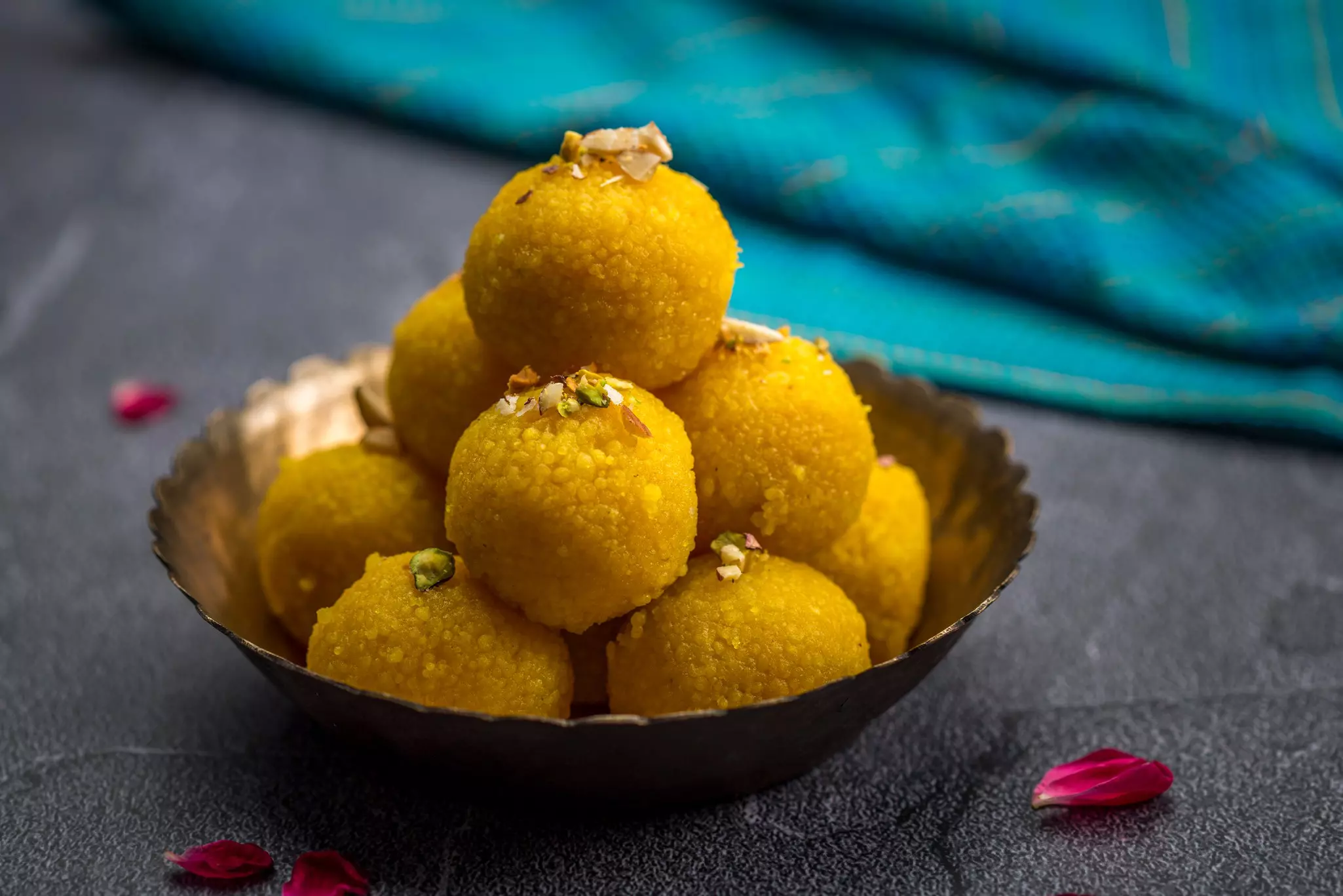 Motichoor ladoo, ball-shaped sweets in a metal pot on a table