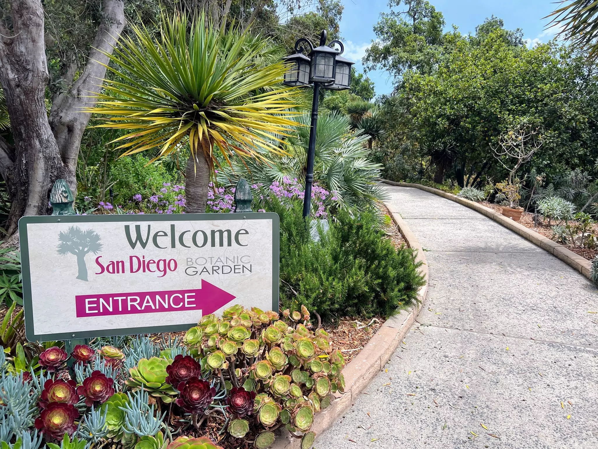 Welcome sign at the and entrance walkway to San Diego Botanic Garden