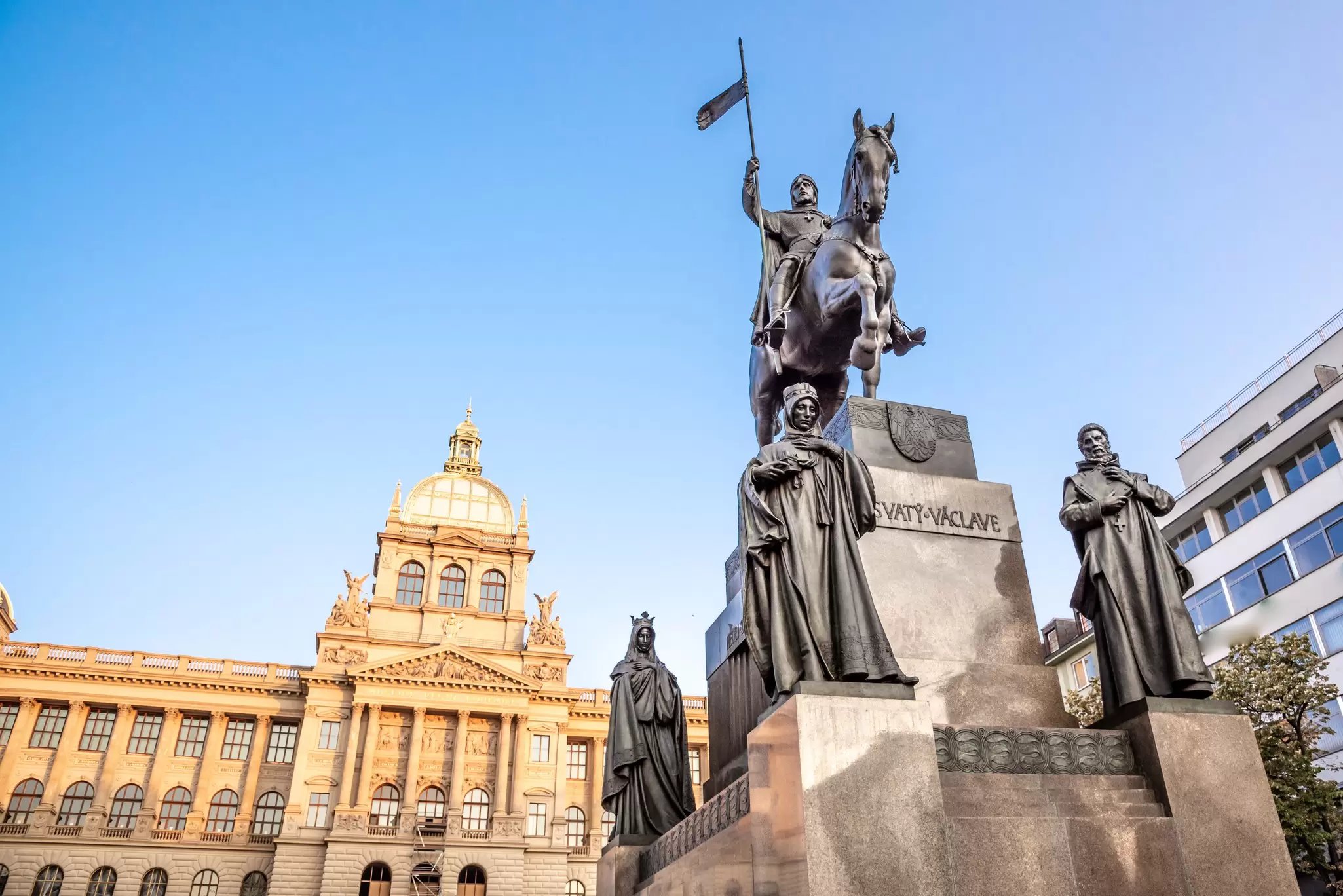 View of the bronze equestrian statue of St Wenceslas at Wenceslas Square, with the historical National Museum in the background in Prague, Czechia.