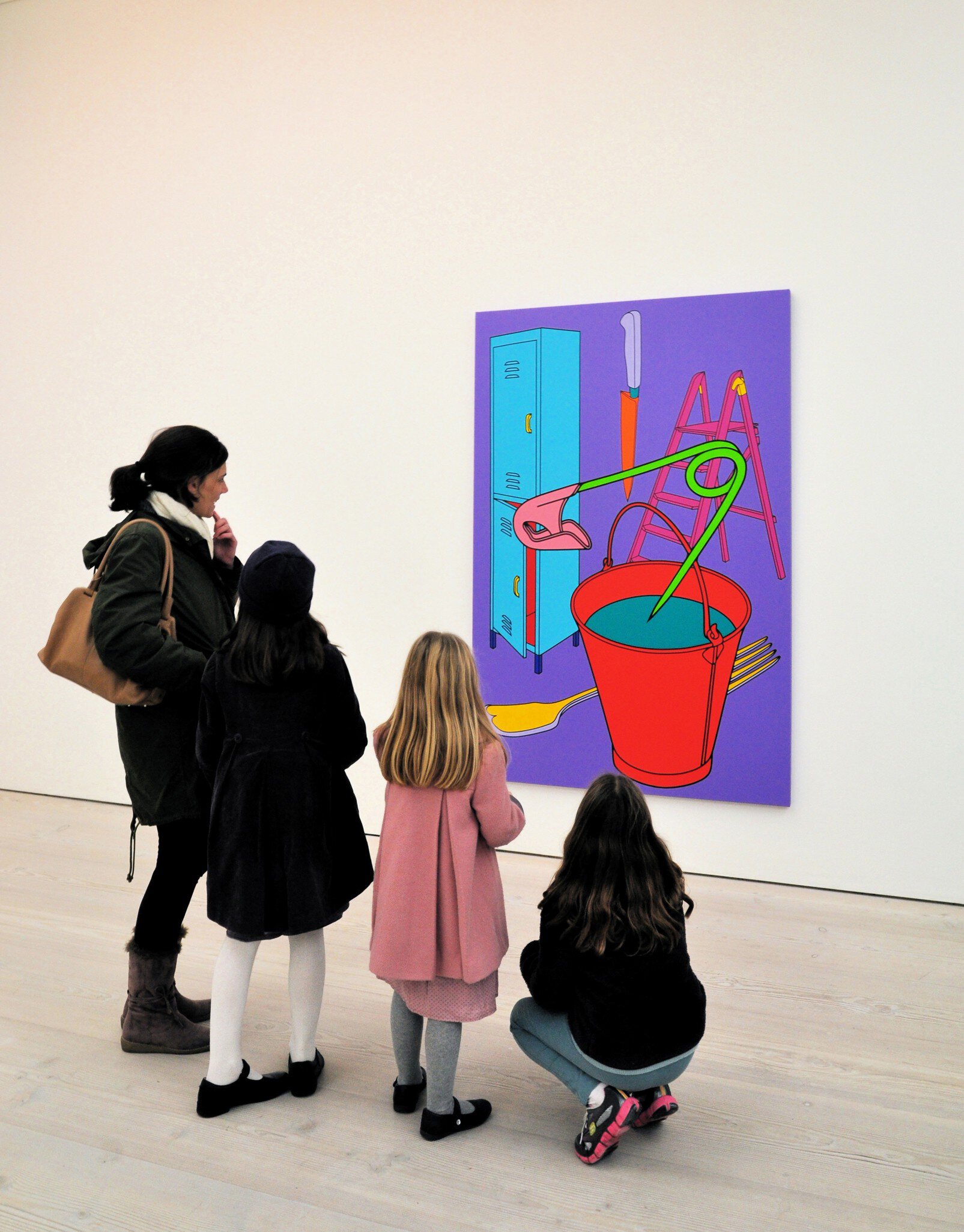 Visitors viewing a painting by Michael-Craig Martin on display at the Saatchi Gallery in London, UK.