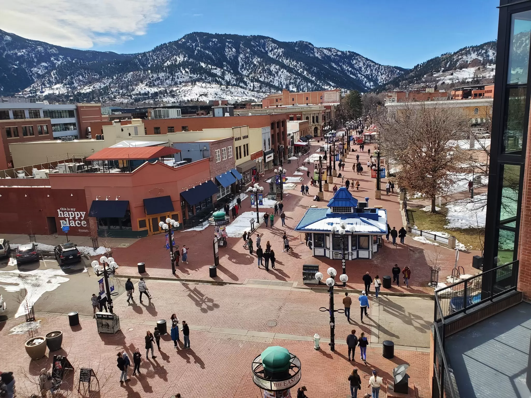 Pedestrians walk down a main shop-lined street on a winter's day: Pearl St, Boulder.