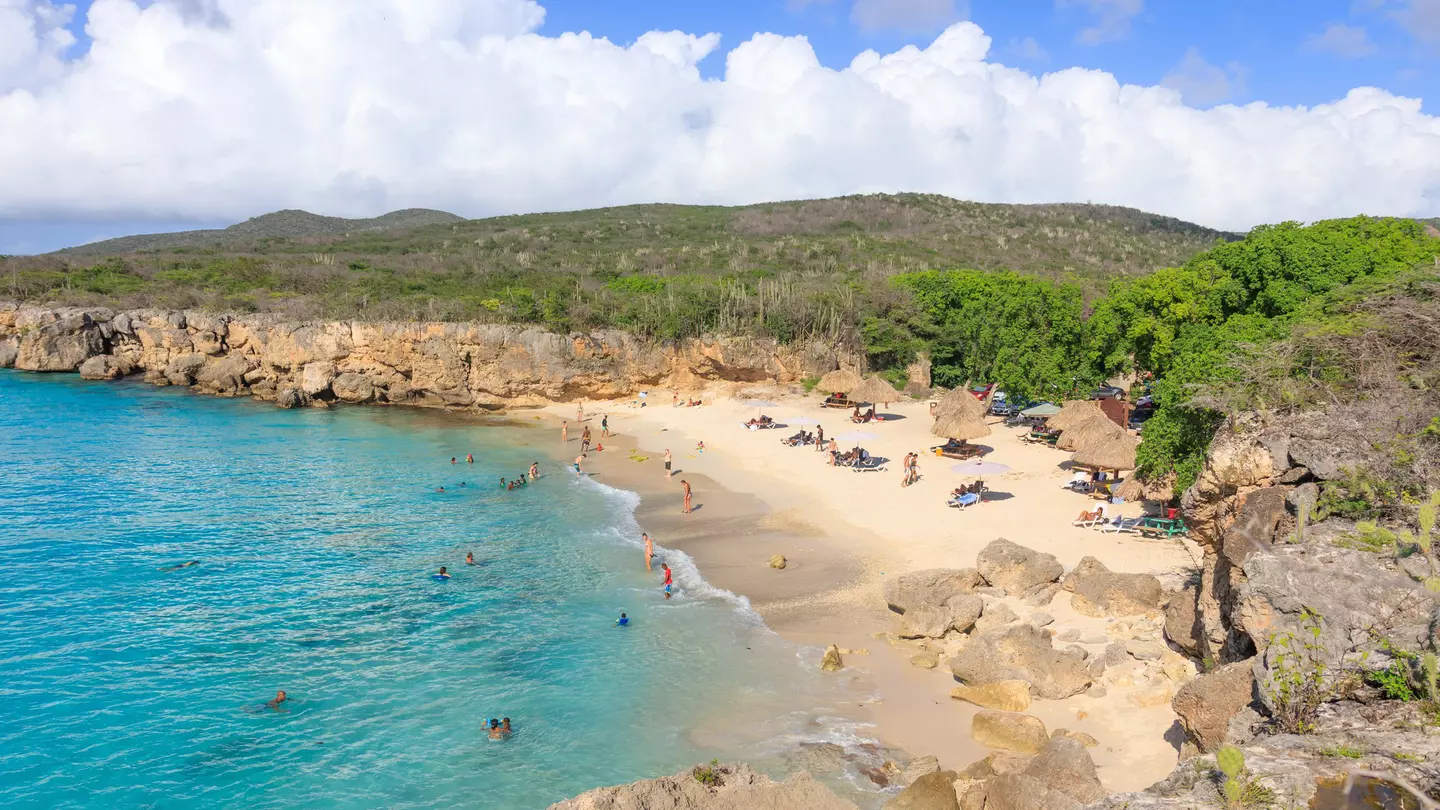 A small sandy cove surrounded by cliffs