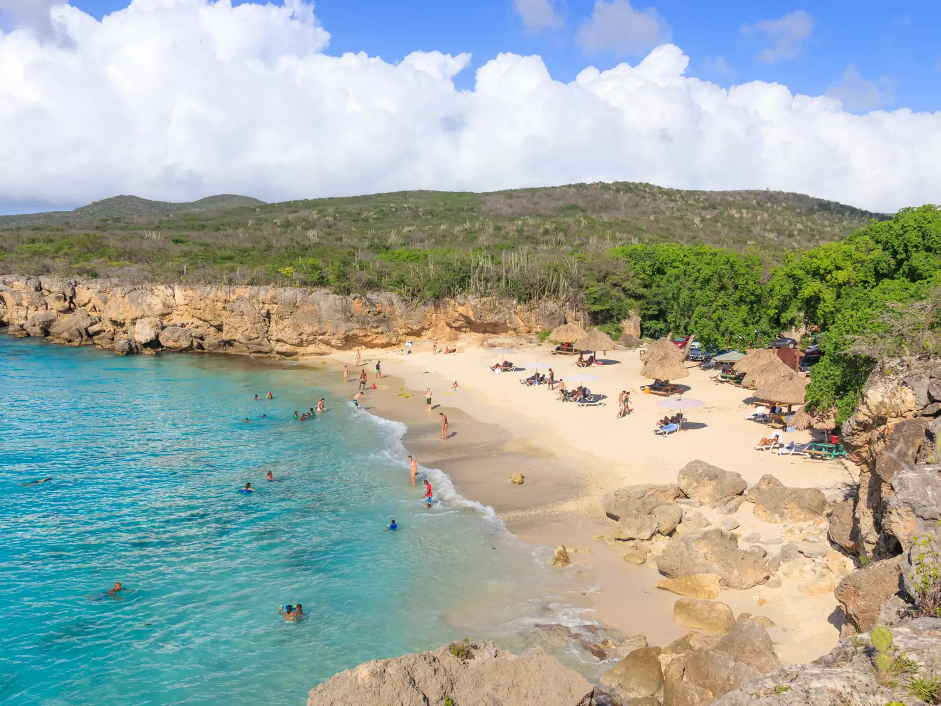 A small sandy cove surrounded by cliffs