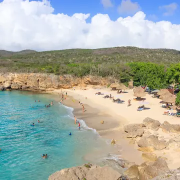 A small sandy cove surrounded by cliffs