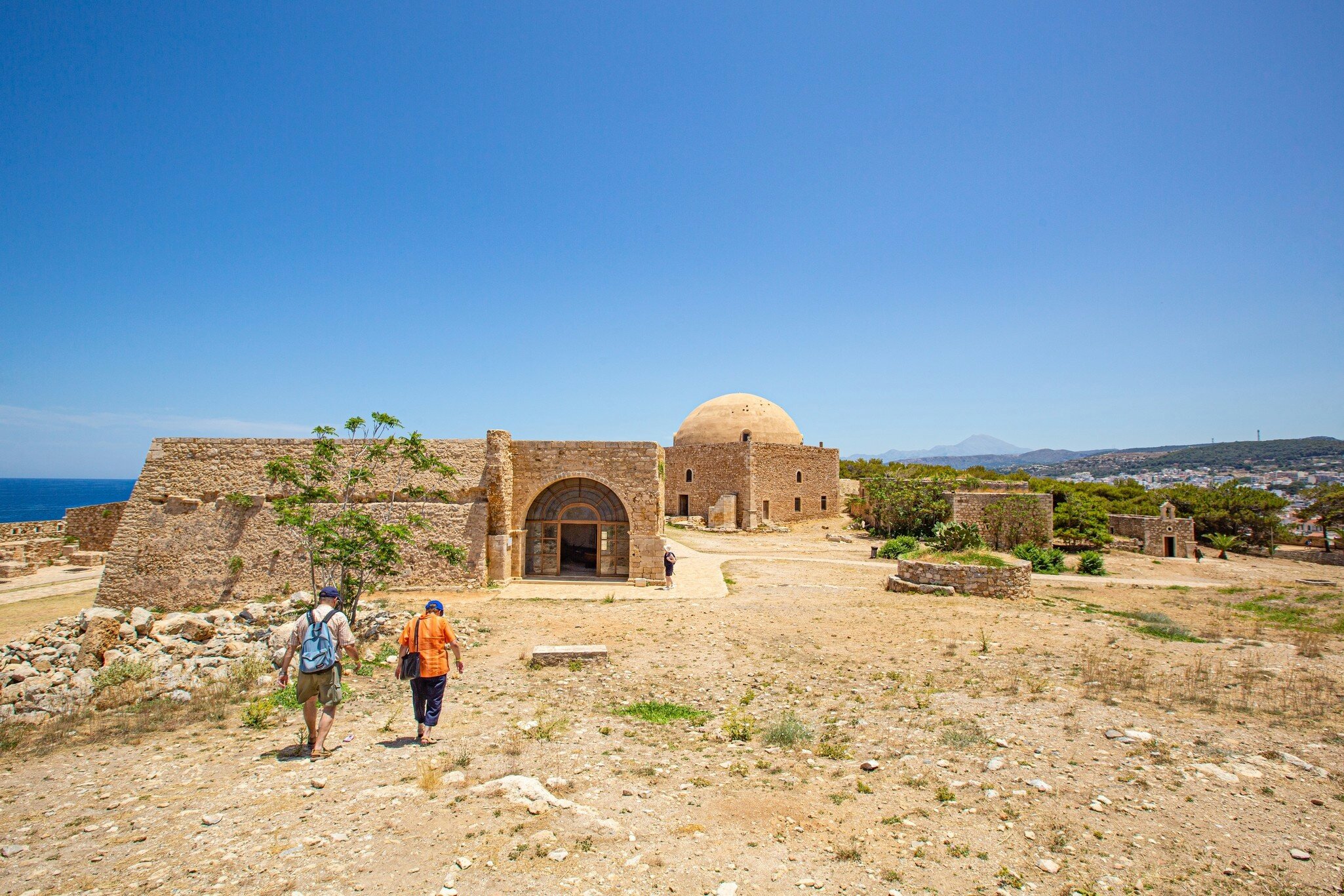 An elderly tourist couple visits the Medieval fortifications in Rethymno fortress during the summer months.