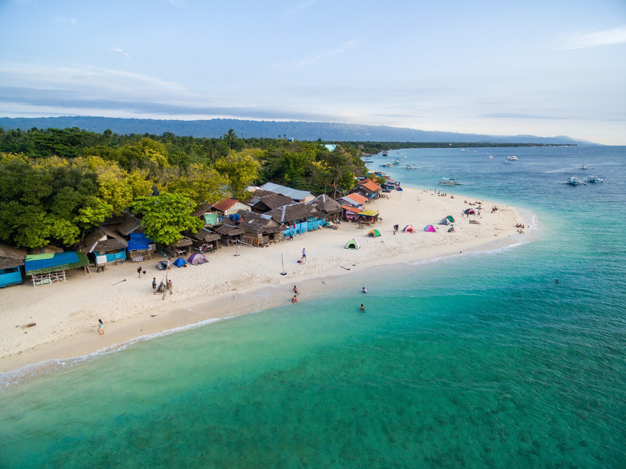 White Beach Moalboal in Cebu, Palawan, Philippines. Boat and Ocean Water and Beach.; Shutterstock ID 1043799535;