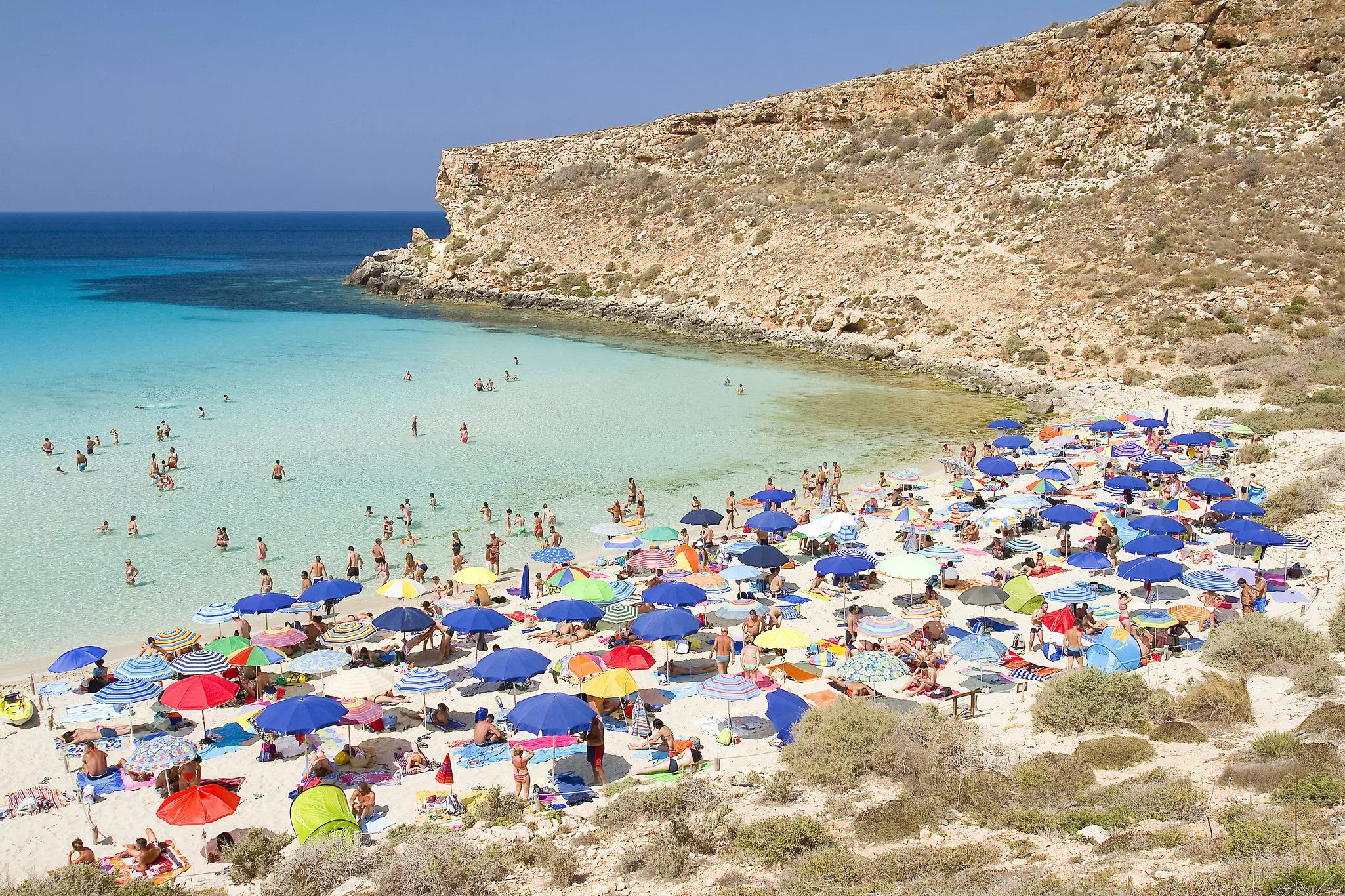 Tourists on the beach Spiaggia dei Conigli on Lampedusa, Sicily, Italy.