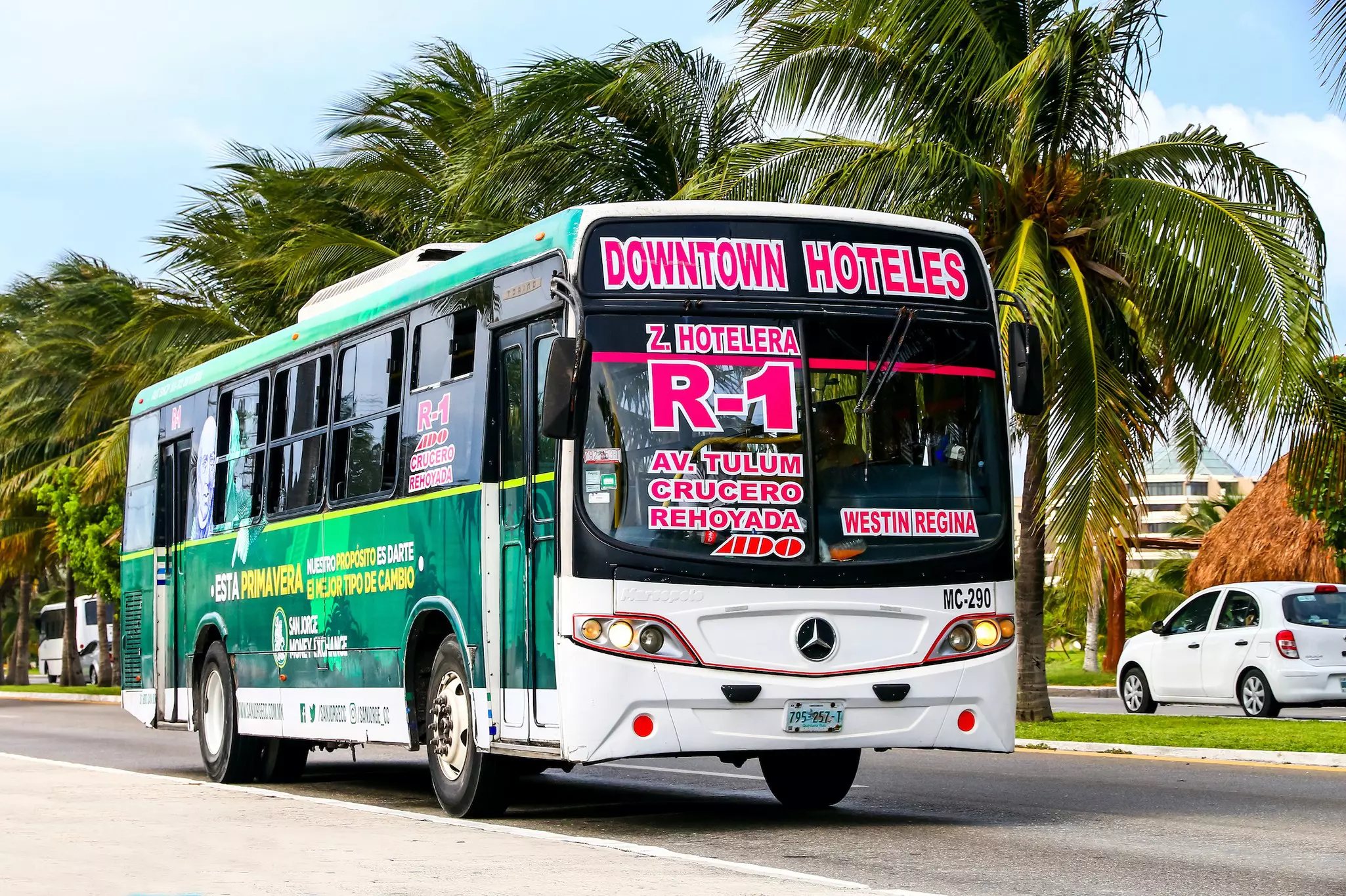 A local bus driving along the street in Cancún, Mexico