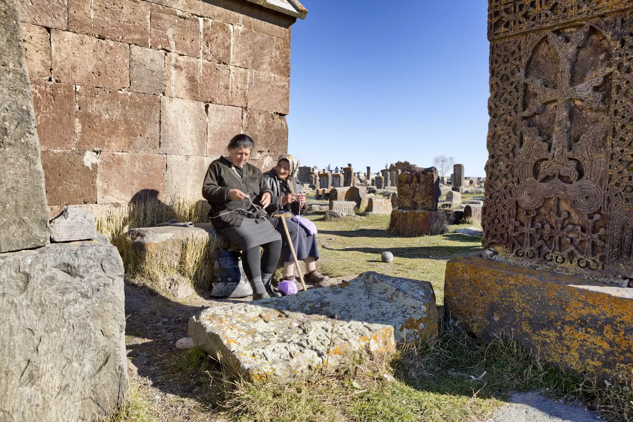 Senior Armenian women knitting and talking at Noratus Cemetery.