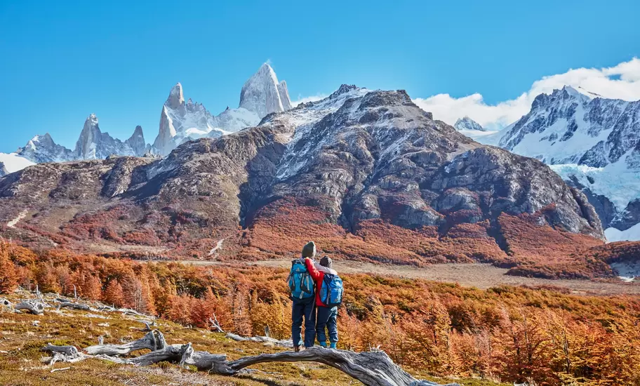 Two hikers gaze out to Monte Fitz Roy in Patagonia, Argentina.