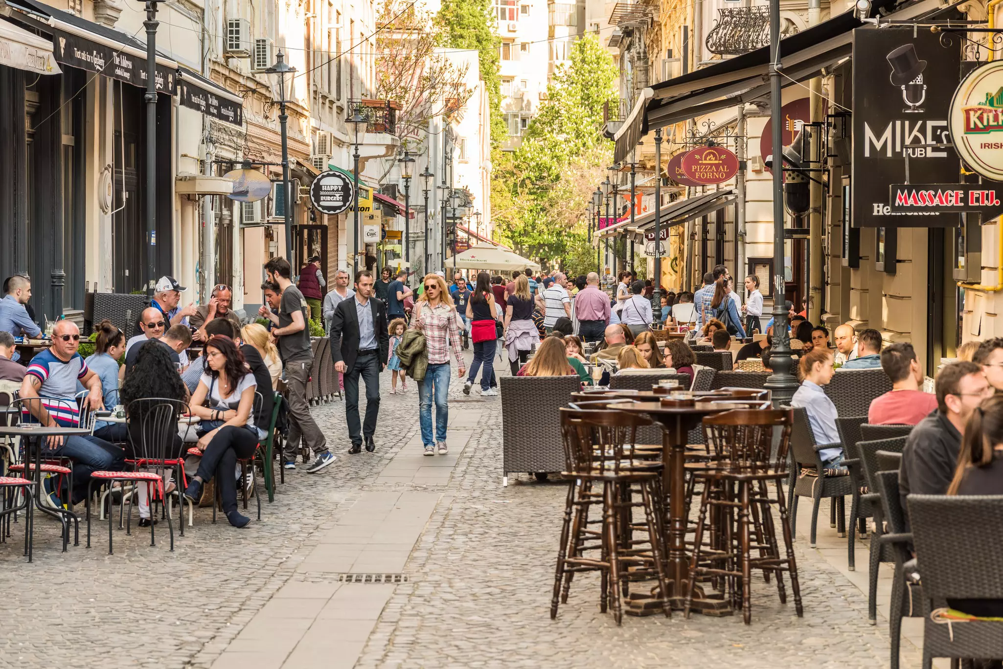 People at pavement cafes on Lipscani Street in old Bucharest.