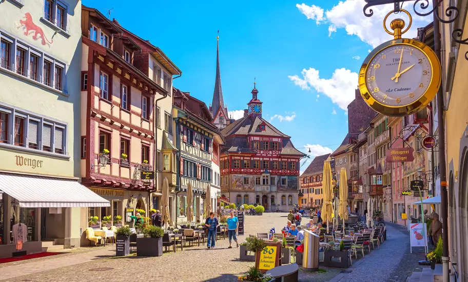 Painted half-timbered houses and town hall on Rathausplatz, Stein am Rhein, Switzerland, with a gold IWC Schaffhausen clock