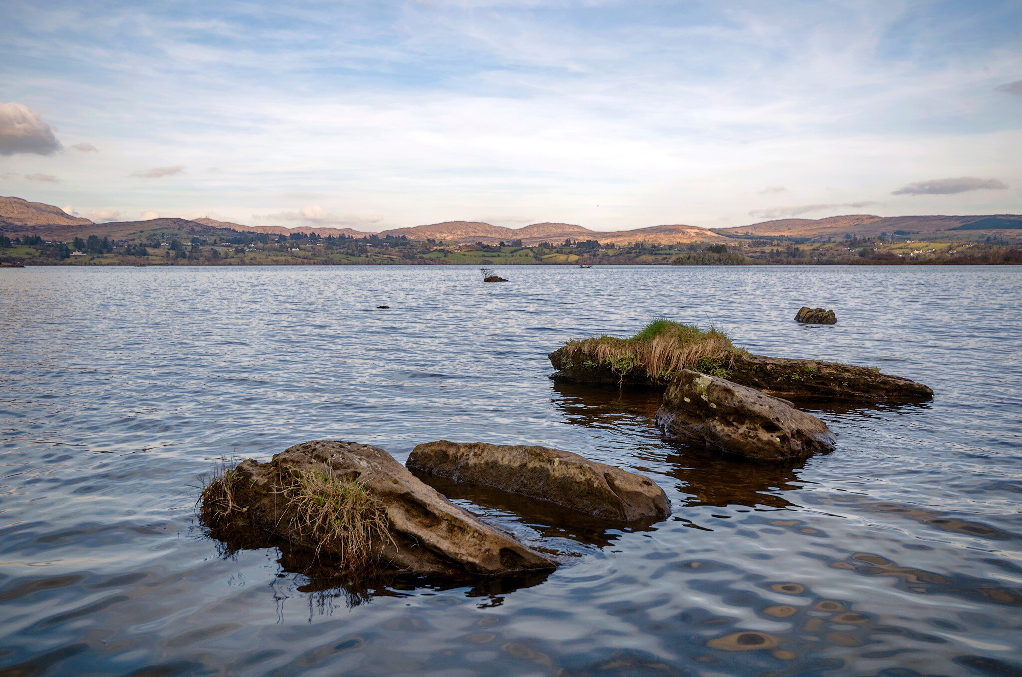 A view across lough Eske with rocks in the foreground.; Shutterstock ID 1090366670;