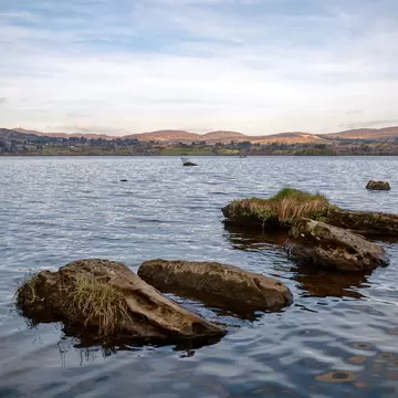A view across lough Eske with rocks in the foreground.; Shutterstock ID 1090366670;