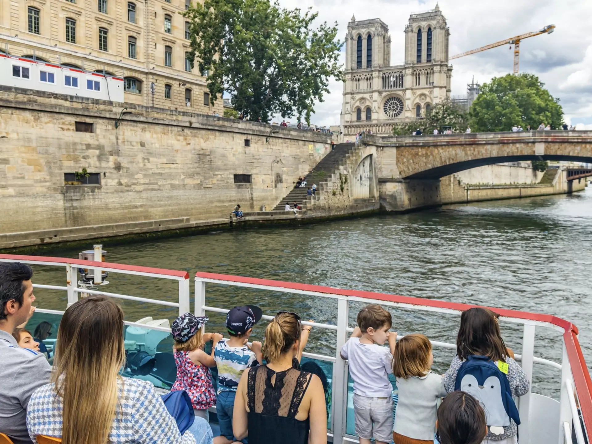 A boat ride on the Seine is a marvelous way to show your kids Paris. JeanLucIchard/Shutterstock