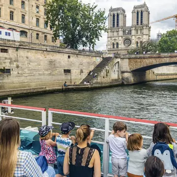 A boat ride on the Seine is a marvelous way to show your kids Paris. JeanLucIchard/Shutterstock
