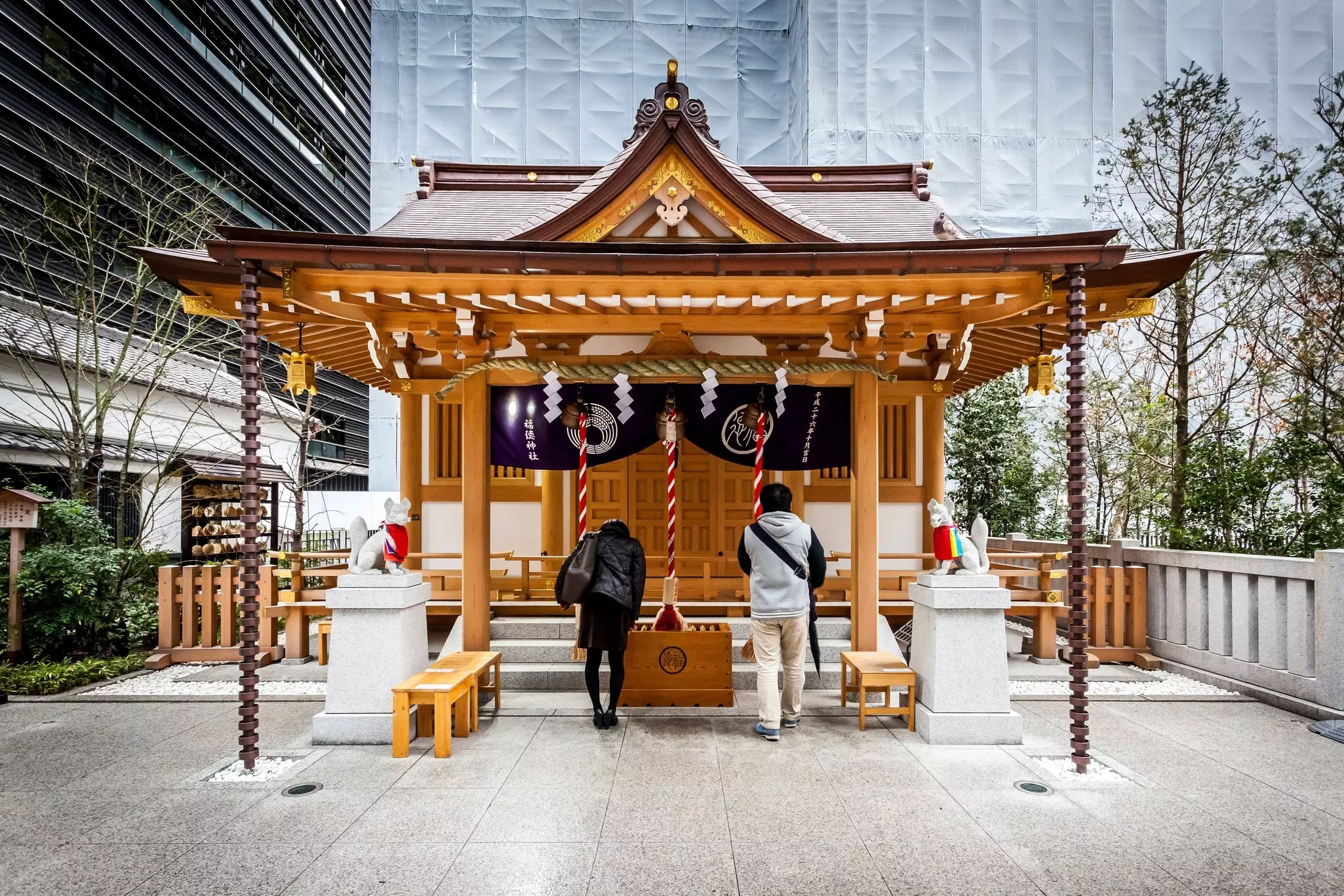 People visiting the Fukutoku-jinja in the Nihonbashi business district, Tokyo, Japan.