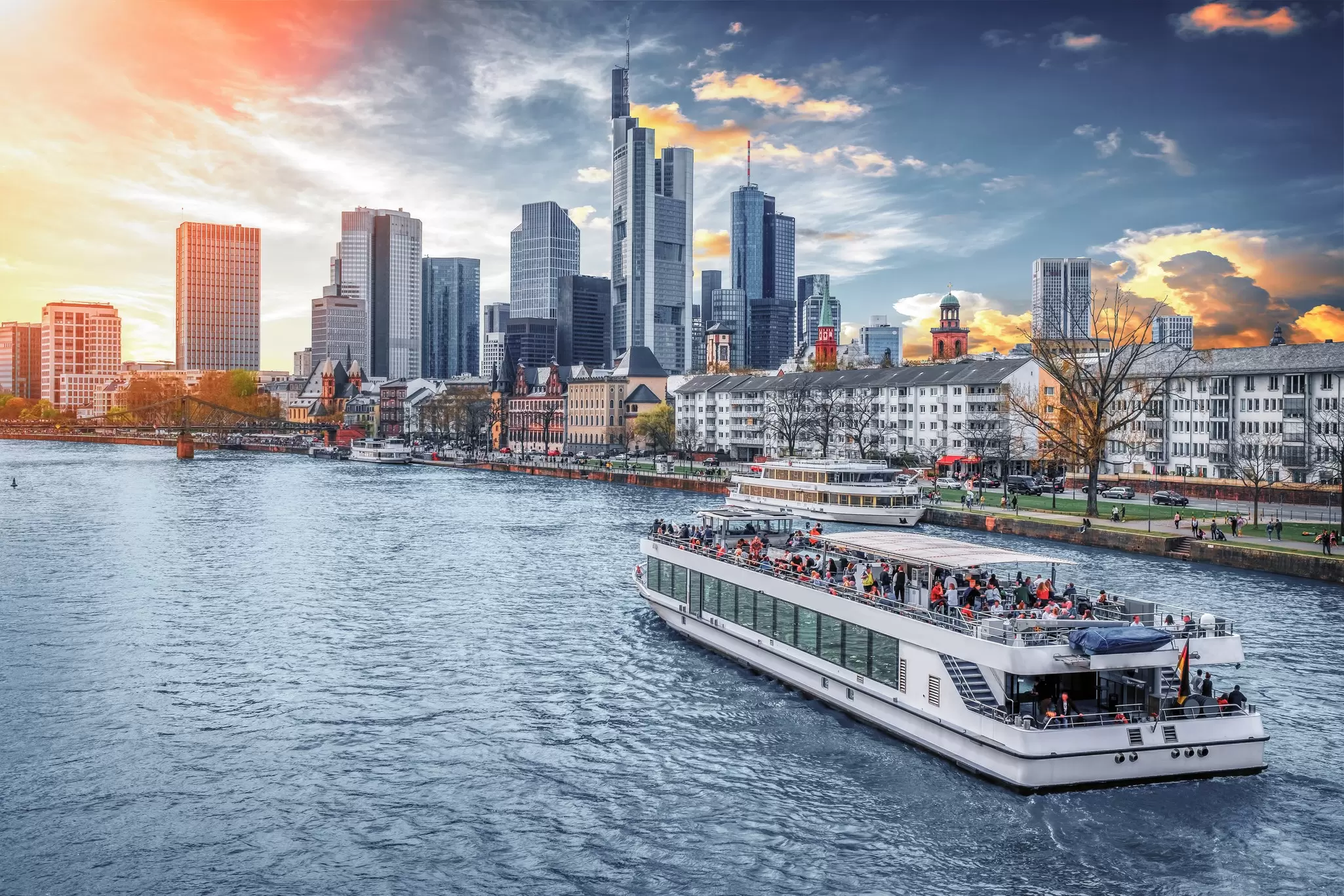 A boat cruises on the River Main with Main Tower and the financial district in the background. Augustin Lazaroiu/Shutterstock