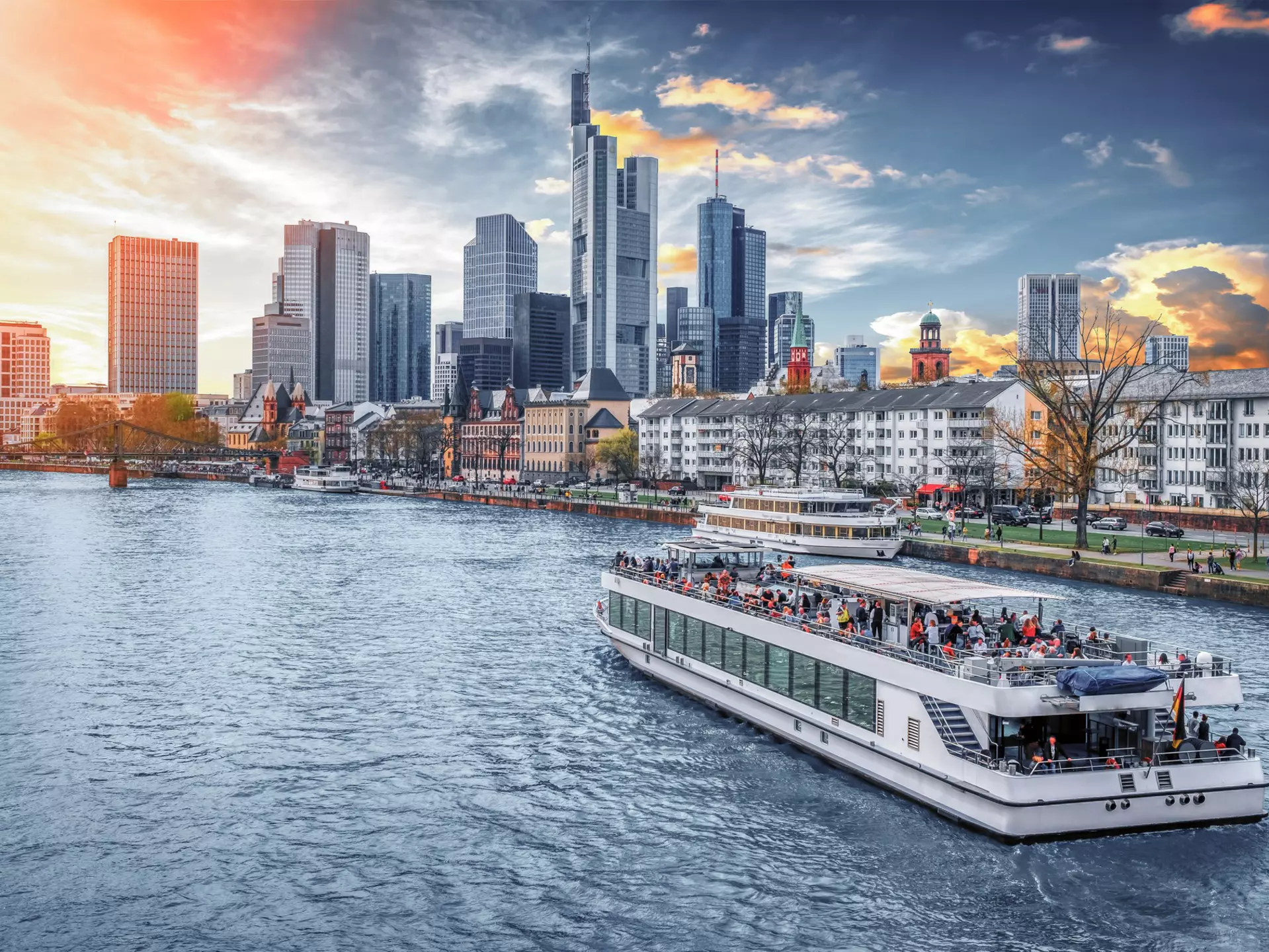 A boat cruises on the River Main with Main Tower and the financial district in the background. Augustin Lazaroiu/Shutterstock