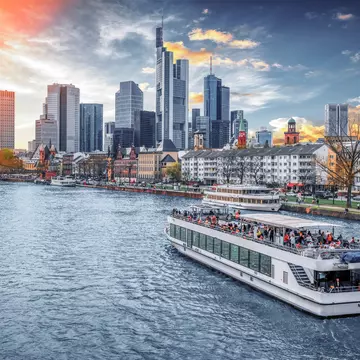 A boat cruises on the River Main with Main Tower and the financial district in the background. Augustin Lazaroiu/Shutterstock