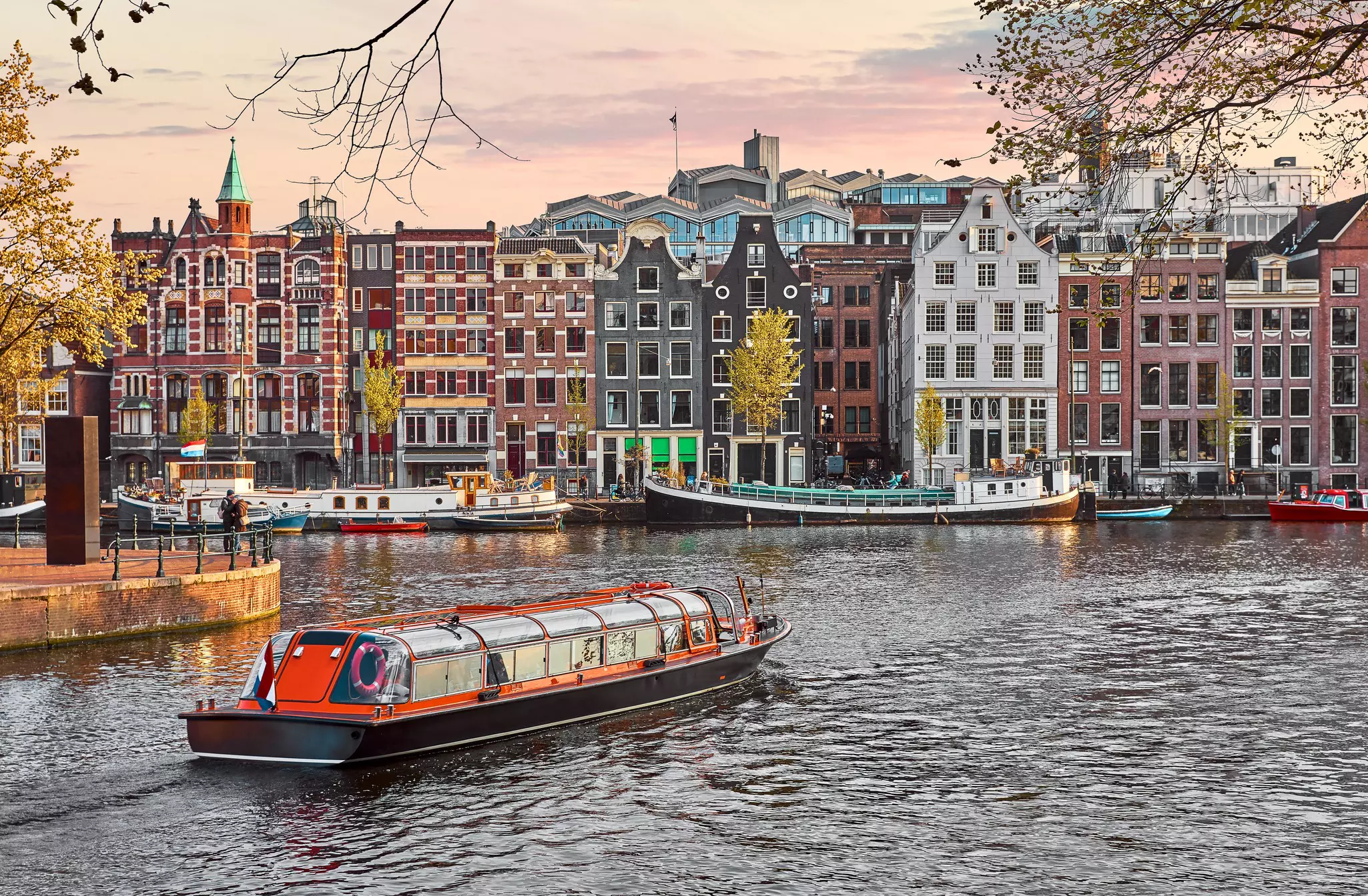 Channel in Amsterdam Netherlands houses river Amstel landmark old european city spring landscape.