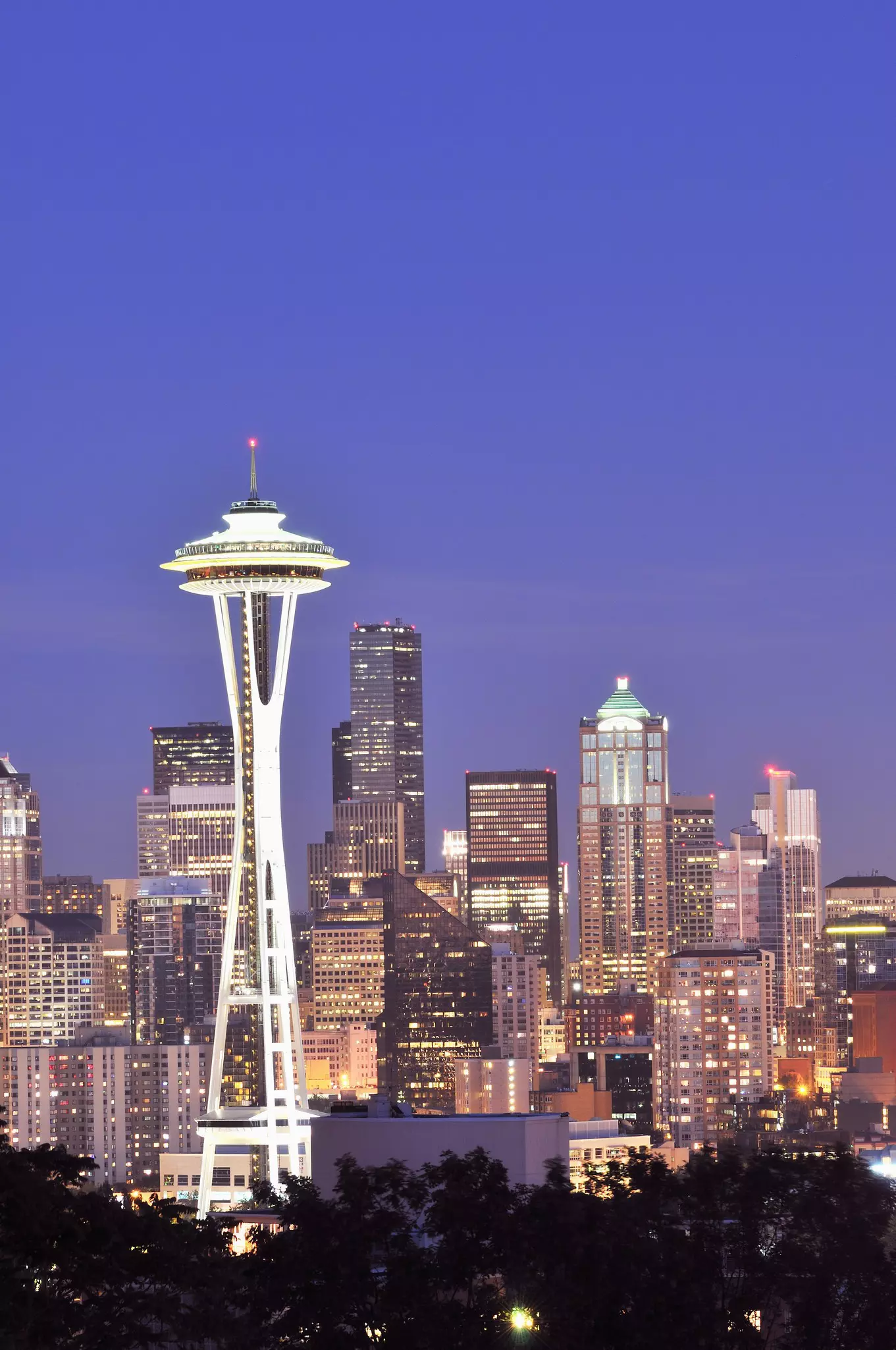 A large UFO-like dish sits on top of tall white legs and dominates the skyline of the city of Seattle