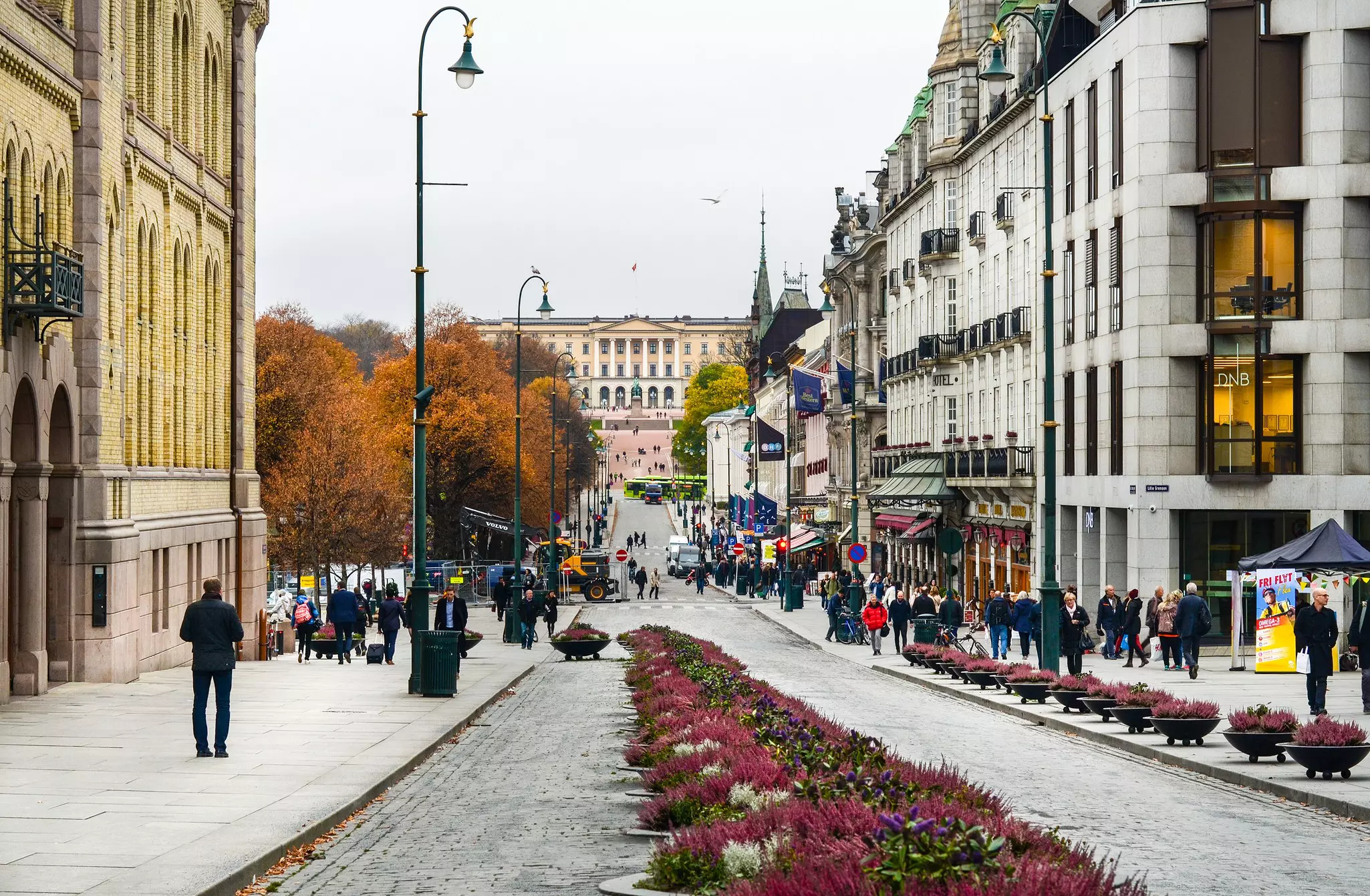A long street with a flower bed in the middle leads to the Parliament building in Oslo.