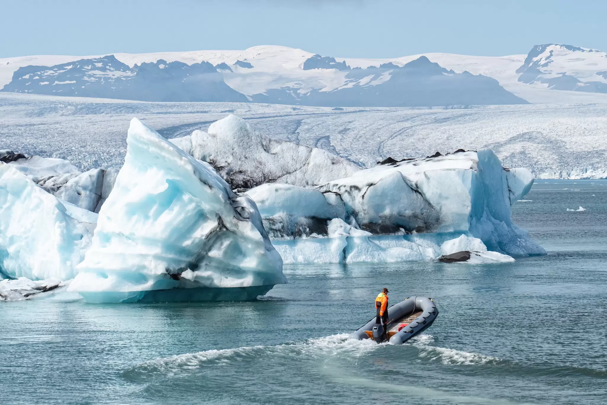 View of a boat riding through the beautiful winter landscape of the Jökulsárlón glacier lagoon in Iceland.