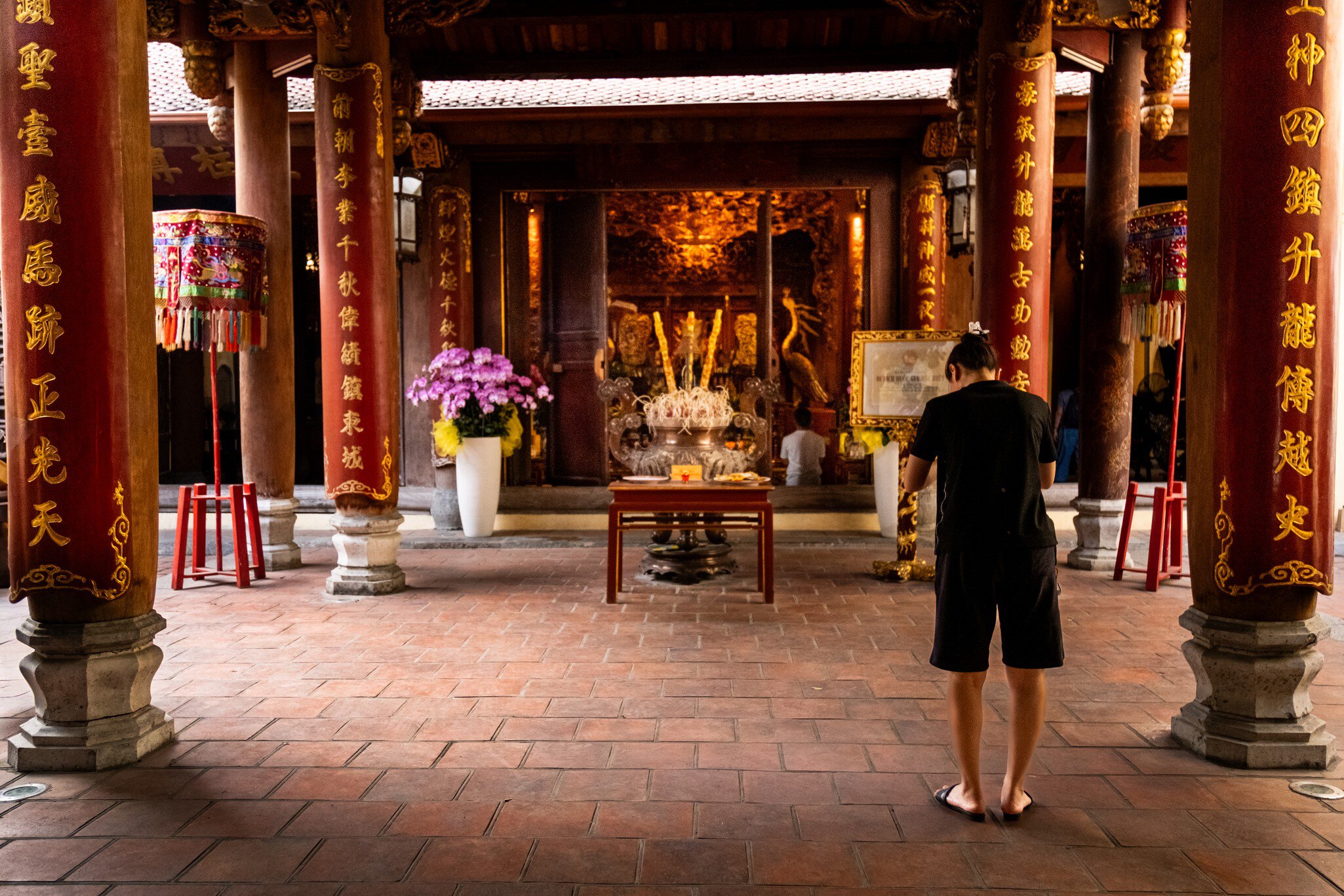 A woman praying inside Bach Ma Temple in Hanoi, Vietnam.