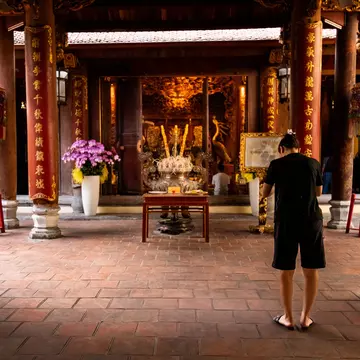 A woman praying inside Bach Ma Temple in Hanoi, Vietnam.