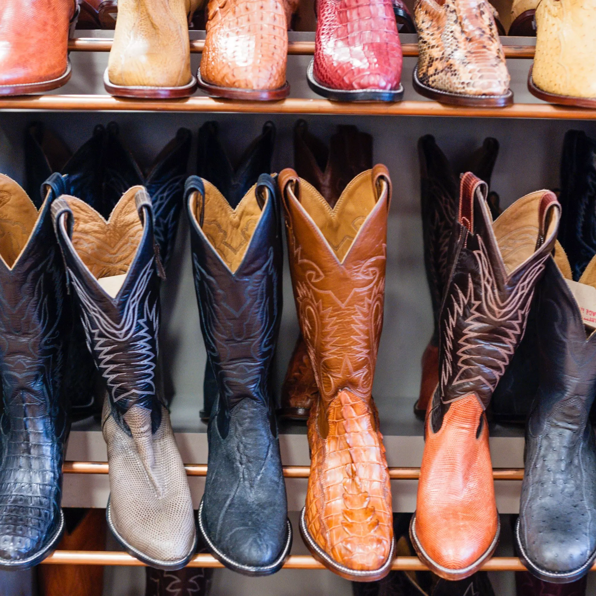 Cowboy boots on display at a shoe store.