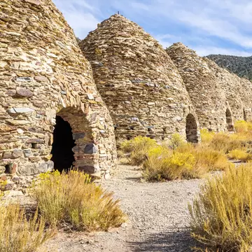 Woman sightseeing at the charcoal kilns in Death Valley National Park.