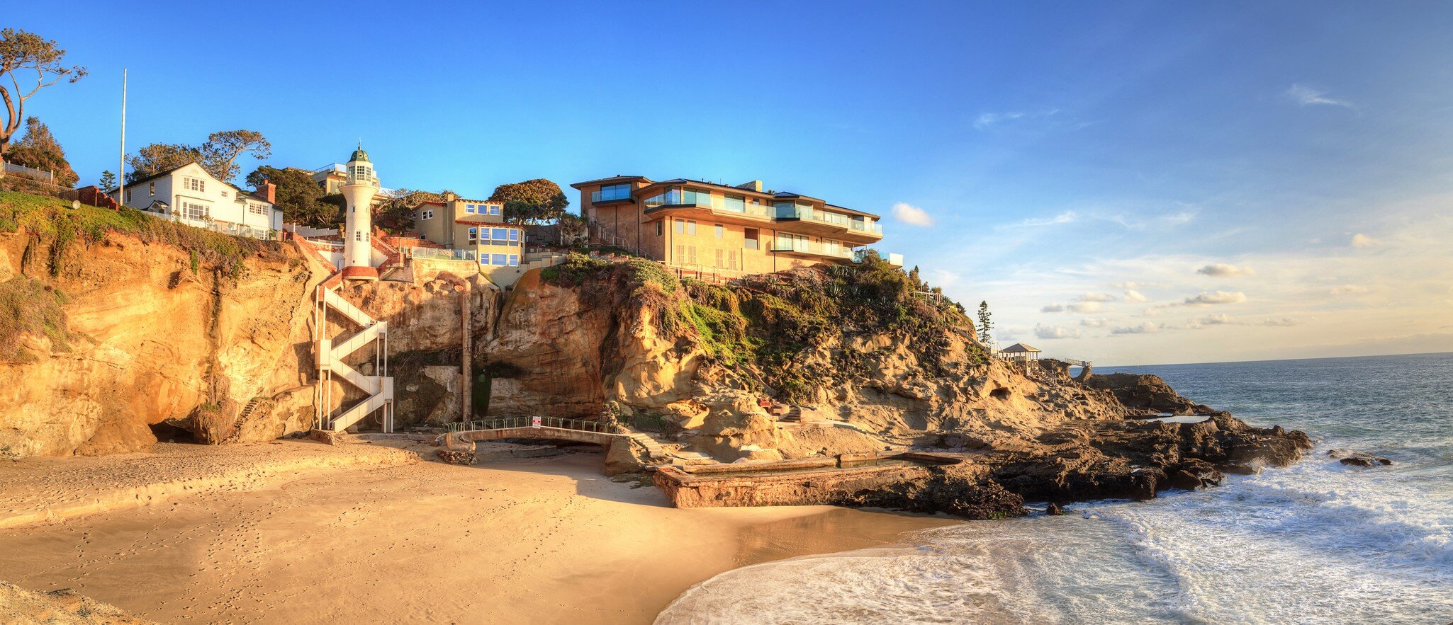 Blue sky over One Thousand Steps Beach with tidal pools and cliffs in Laguna Beach, California.