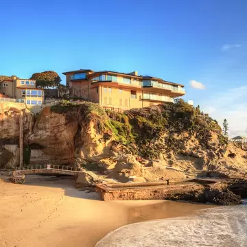 Blue sky over One Thousand Steps Beach with tidal pools and cliffs in Laguna Beach, California.